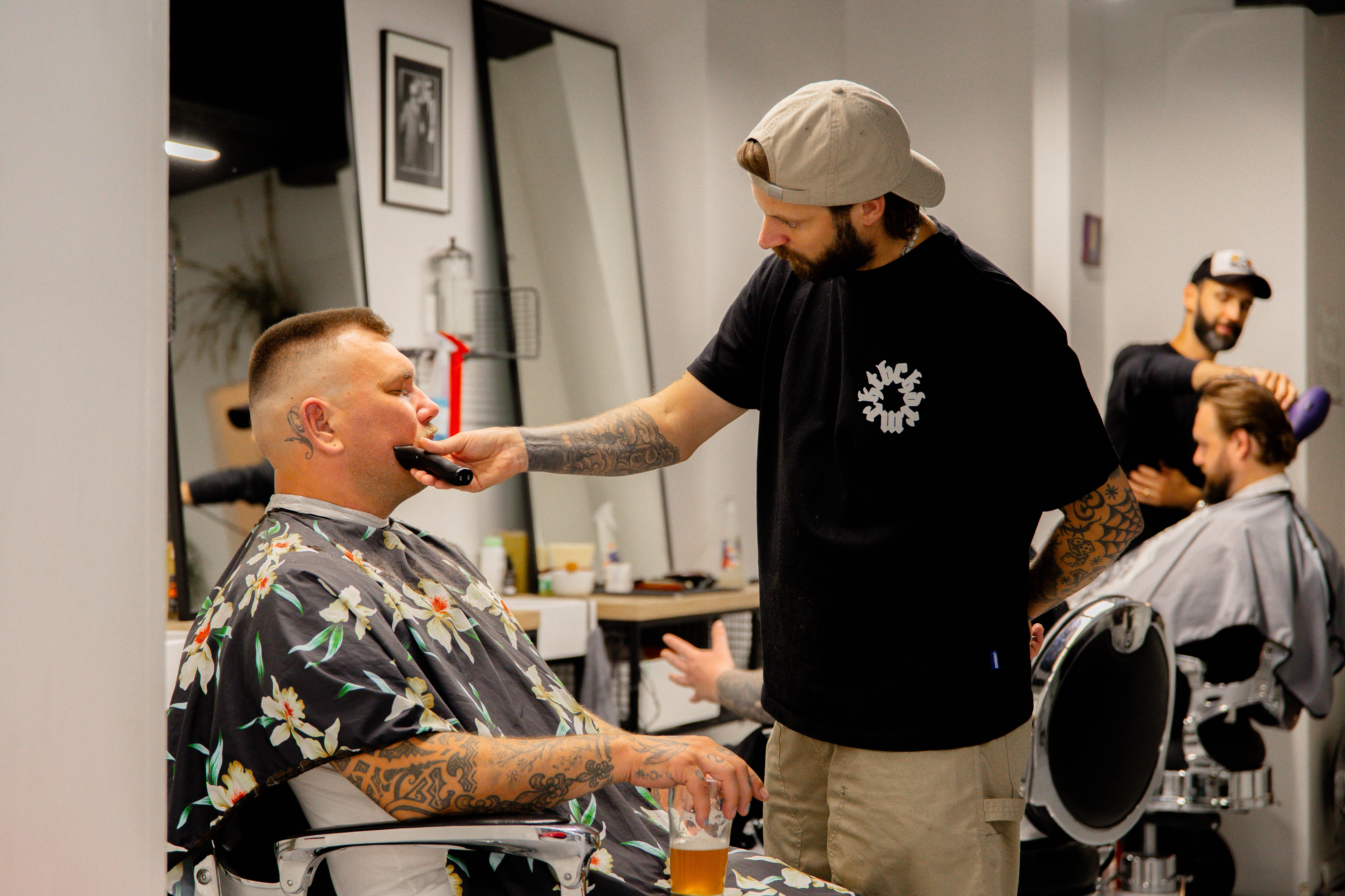 Barbers working with clients at BARBERS HUB